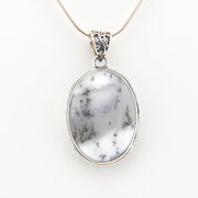 Pendant with white marbled stone and silver frame on a white background