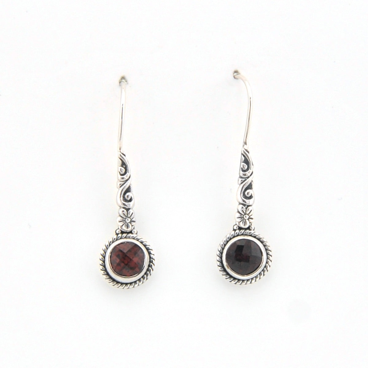 Pair of silver earrings with gemstones on a white background