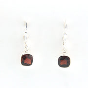 Pair of earrings with square gemstones on a white background