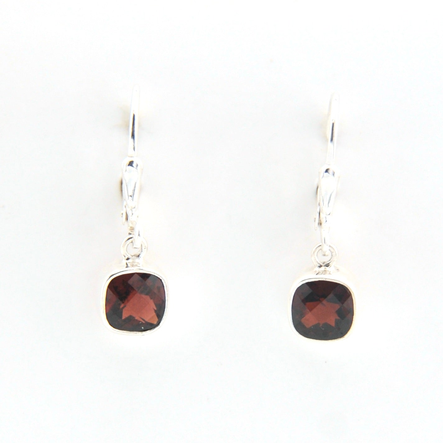 Pair of earrings with square gemstones on a white background