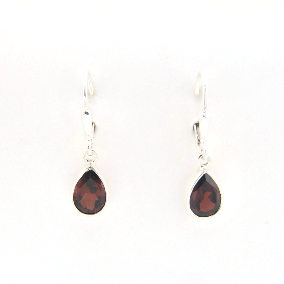 Teardrop-shaped earrings with red stones on a white background