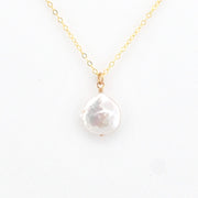 Pearl necklace with gold chain on a white background