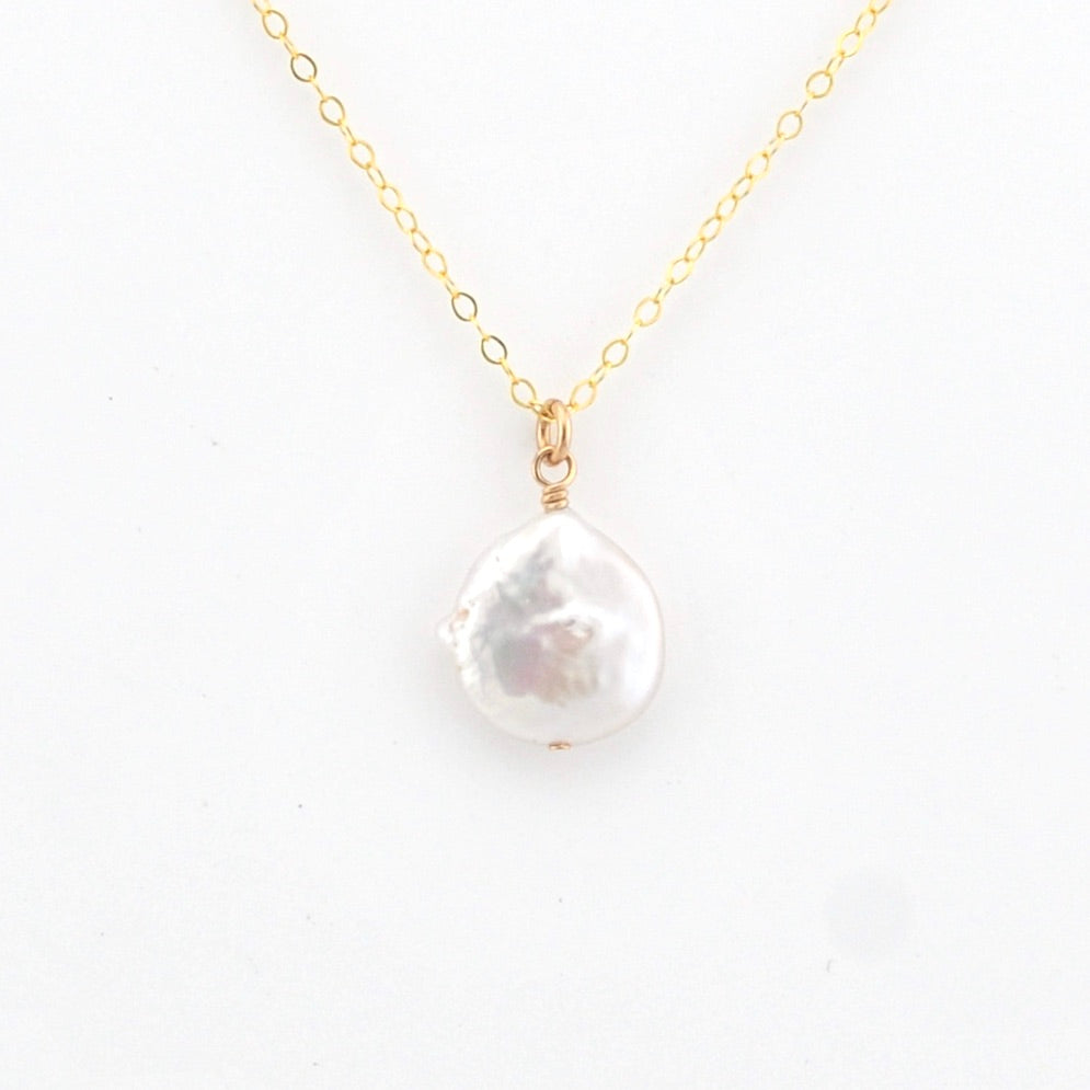 Pearl necklace with gold chain on a white background