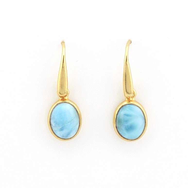 A pair of gold drop earrings with oval light blue marbled gemstone pendants, shown on a plain white background.