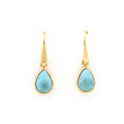 A pair of gold drop earrings with teardrop-shaped light blue larimar stones, shown against a plain white background.