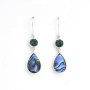 Teardrop-shaped earrings with green gemstones on a white background