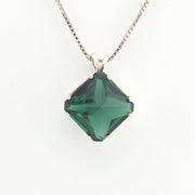 Green gemstone pendant on a white background