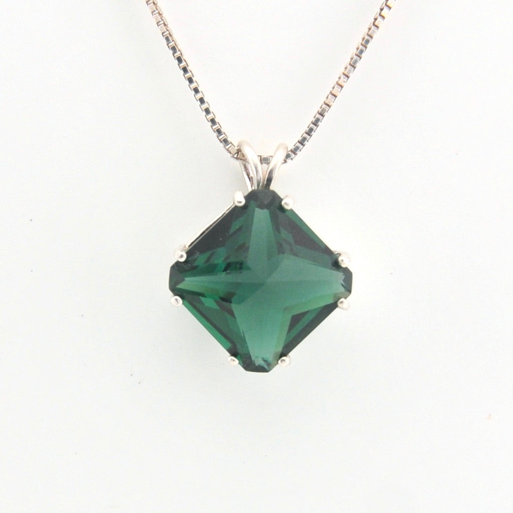 Green gemstone pendant on a white background