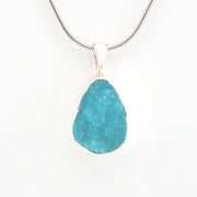 Turquoise pendant necklace on a white background