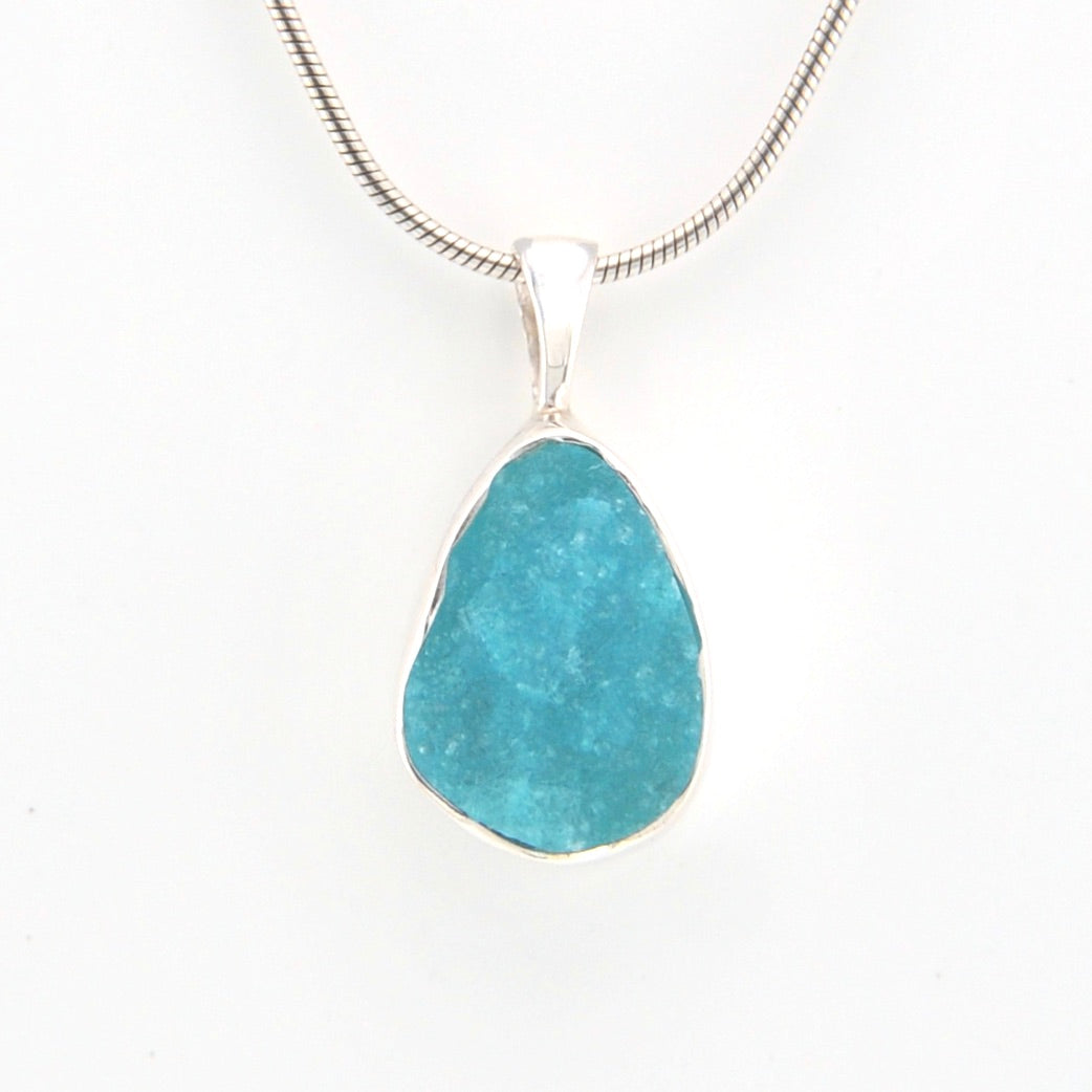 Turquoise pendant necklace on a white background
