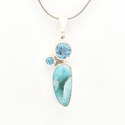 Jewelry pendant with blue stones on a white background