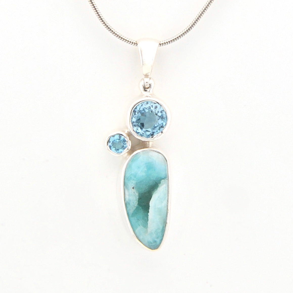 Jewelry pendant with blue stones on a white background