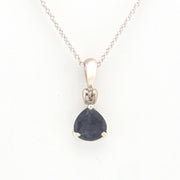 Silver pendant with a blue gemstone on a white background