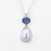 Jewelry with a blue stone and pearl pendant on a white background