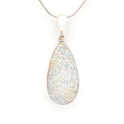 Teardrop-shaped pendant with glittery surface on a white background