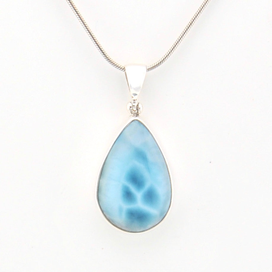 Teardrop-shaped blue pendant on a white background