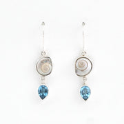 Pair of earrings with shell and blue gemstone drops on a white background