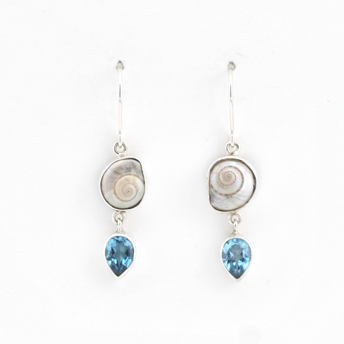 Pair of earrings with shell and blue gemstone drops on a white background
