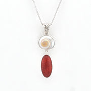 Shell and red coral necklace on a white background