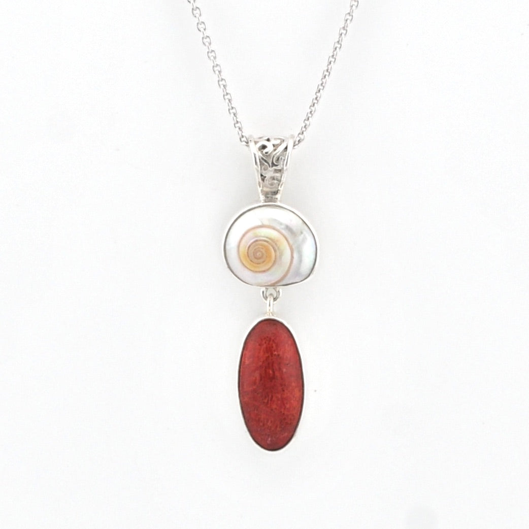 Shell and red coral necklace on a white background