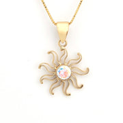 Gold sun-shaped pendant necklace with a colorful center on a white background