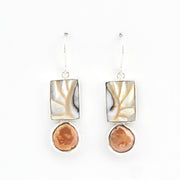 Pair of earrings with shell and pearl on a white background