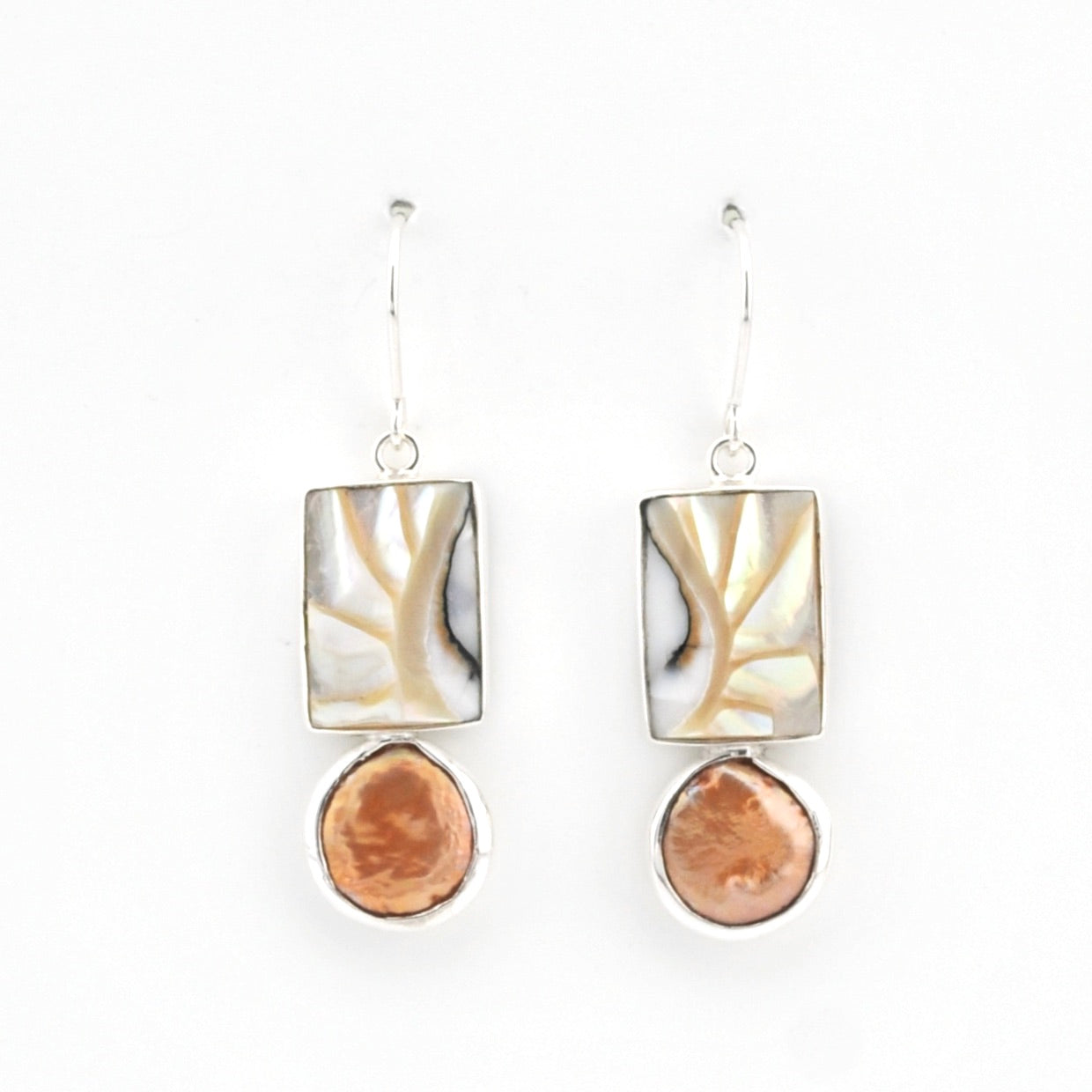 Pair of earrings with shell and pearl on a white background