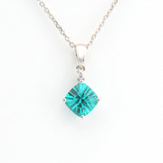 Teal square pendant on a silver chain against a white background