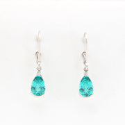 Teardrop-shaped teal earrings on a white background