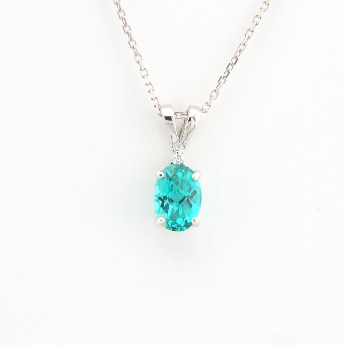 Teal pendant necklace on a white background