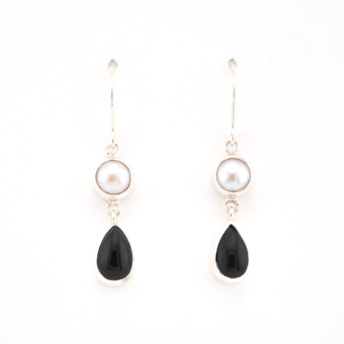 Pair of earrings with black teardrop-shaped stones and pearl-like tops on a white background