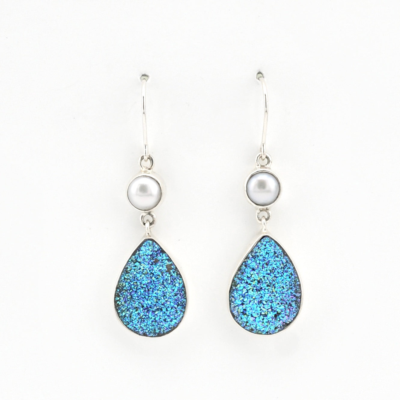 Teardrop-shaped blue glitter earrings with pearl accents on a white background