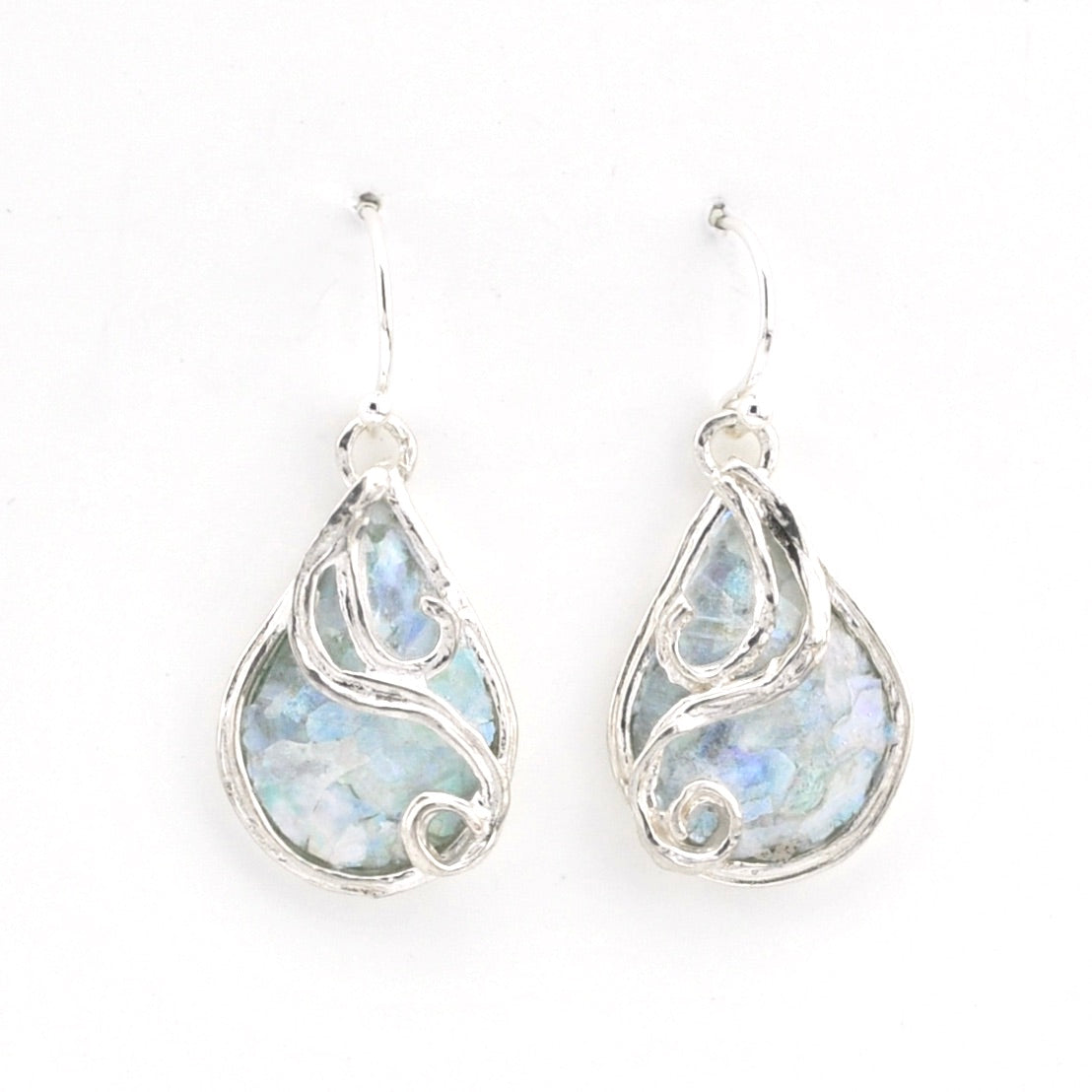 Teardrop-shaped earrings with a silver frame and light blue Roman glass on a white background