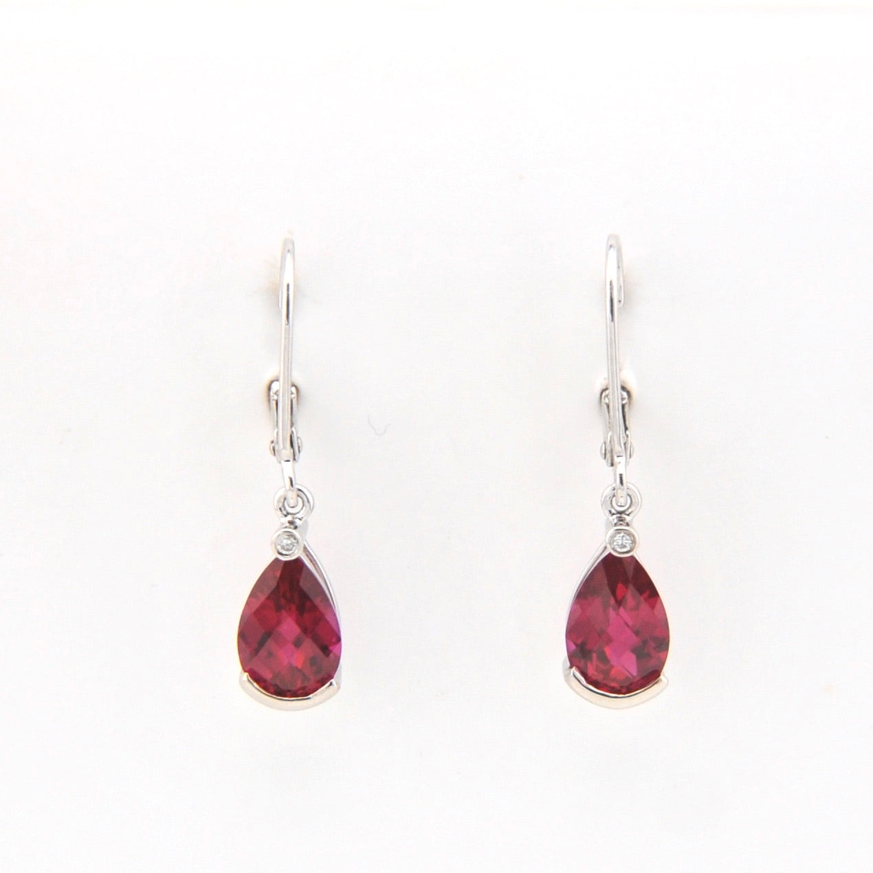 Teardrop-shaped red gemstone earrings on a white background