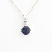 Sapphire pendant necklace on a white background