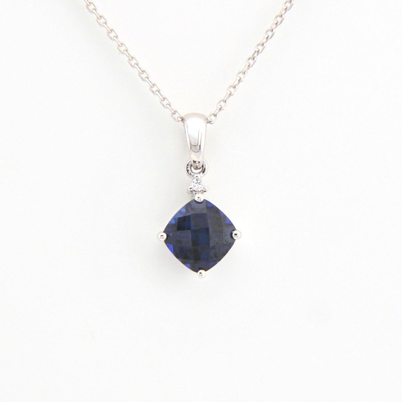 Sapphire pendant necklace on a white background