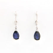 Pair of teardrop-shaped blue gemstone earrings on a white background