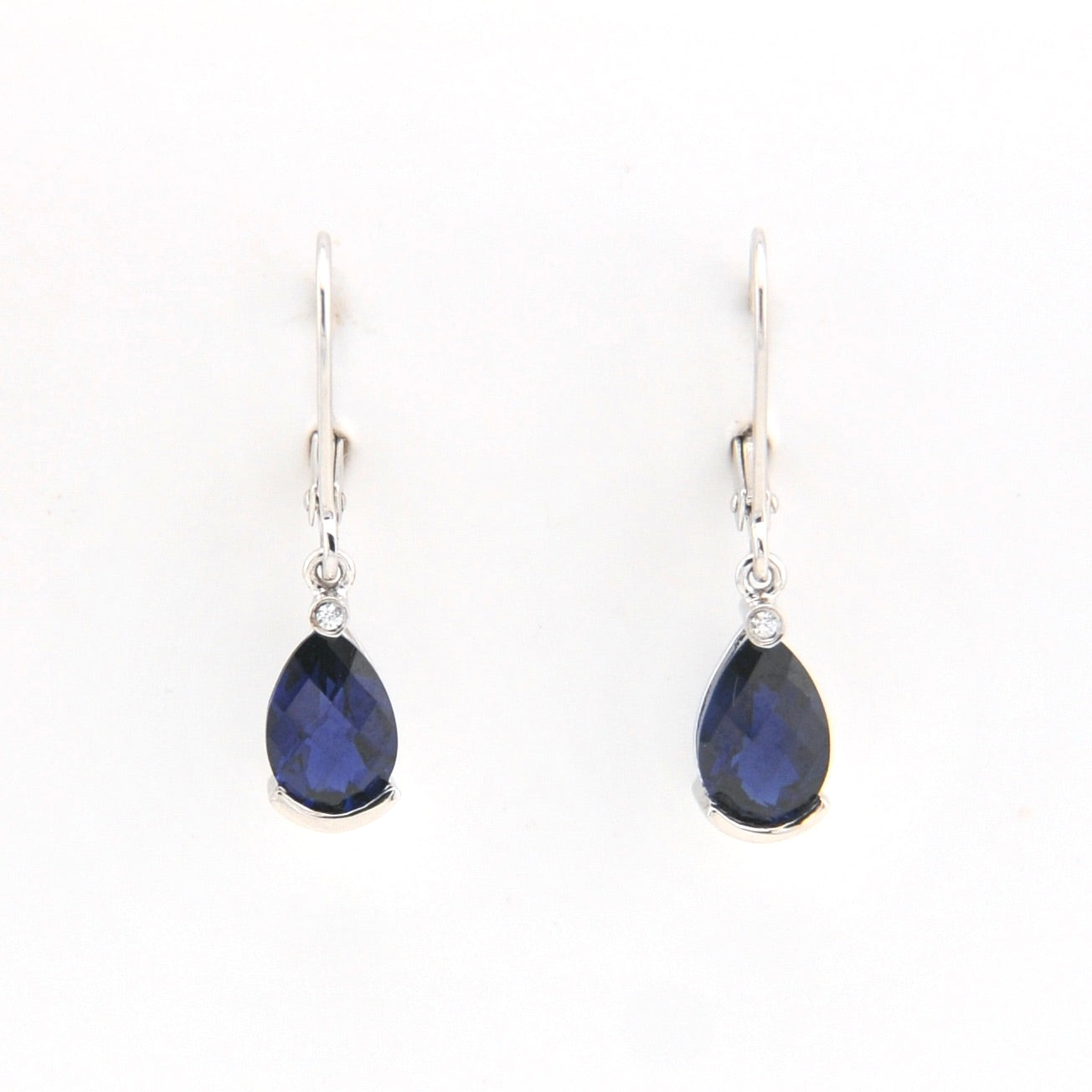 Pair of teardrop-shaped blue gemstone earrings on a white background