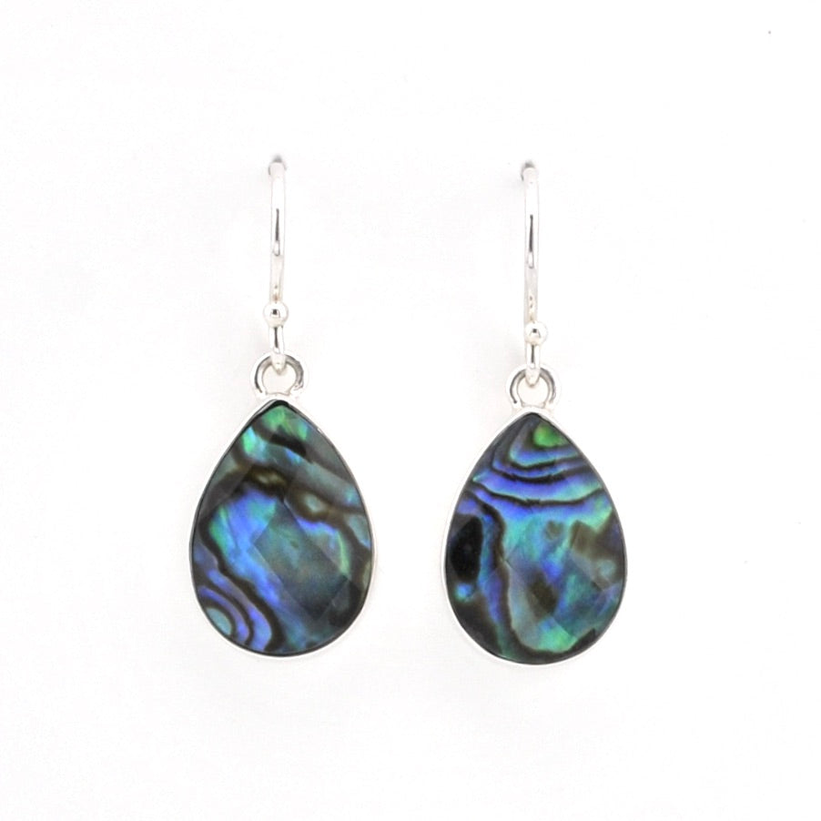 A pair of teardrop-shaped dangle earrings featuring iridescent abalone shell pieces with blue, green, and black swirls, suspended from silver fishhook wires on a plain white background.