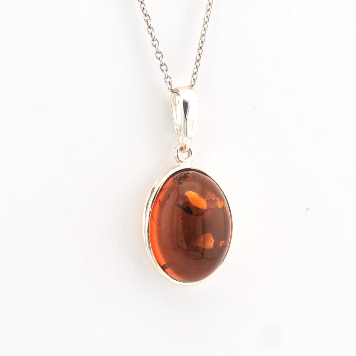 Amber pendant necklace on a white background