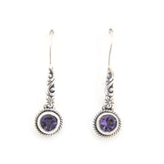 Silver earrings with purple gemstones on a white background