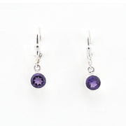 Pair of silver earrings with purple gemstones on a white background
