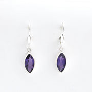 Pair of silver earrings with purple gemstones on a white background