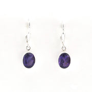 Pair of purple gemstone earrings on a white background