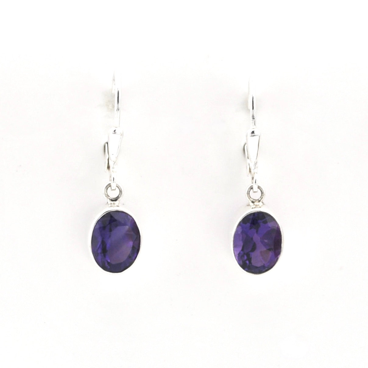 Pair of purple gemstone earrings on a white background