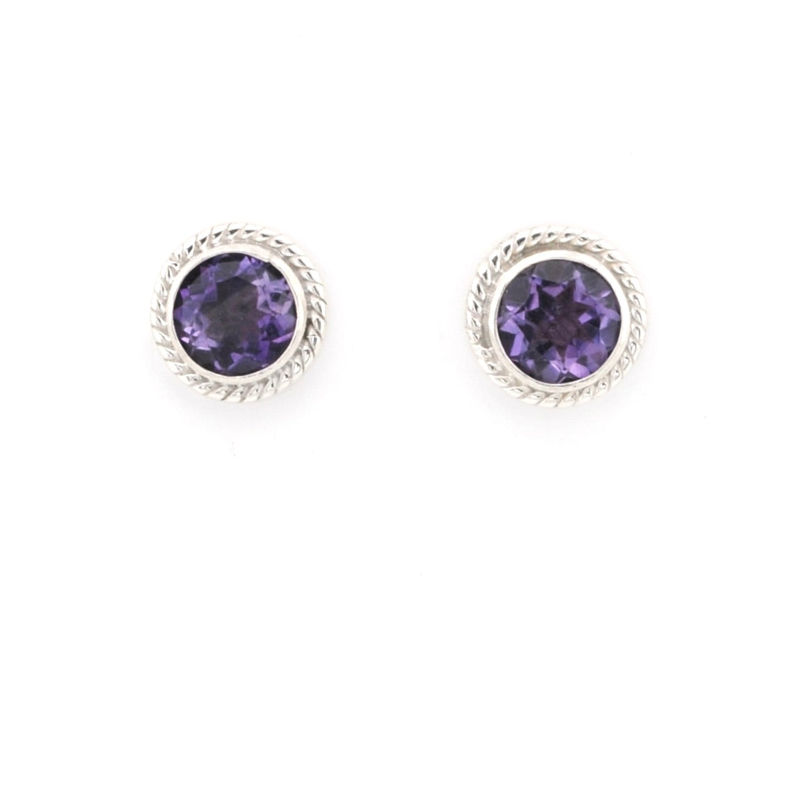 Pair of round purple gemstone earrings with silver rims on a white background