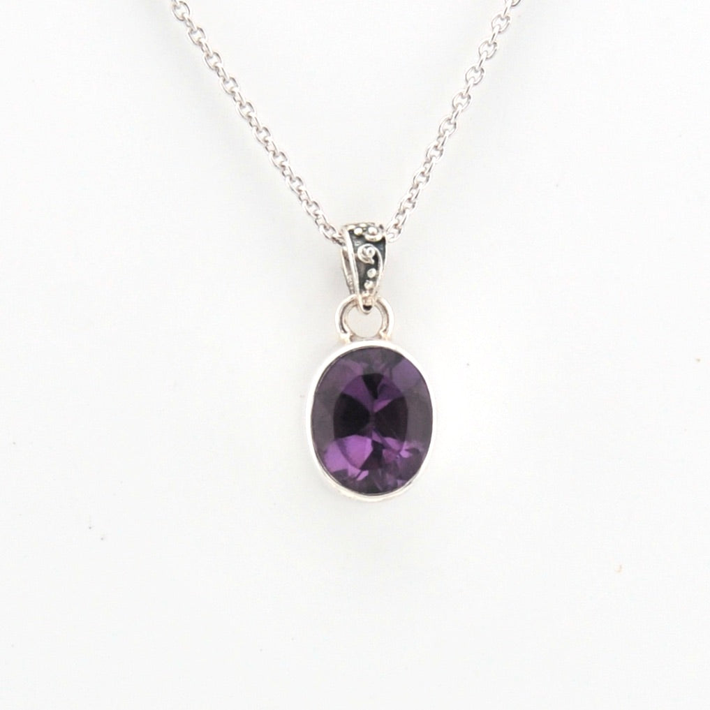 Purple gemstone necklace on a white background
