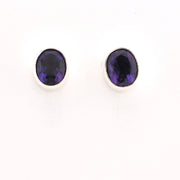 Pair of purple gemstone stud earrings on a white background