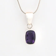 Silver pendant with a purple gemstone on a white background