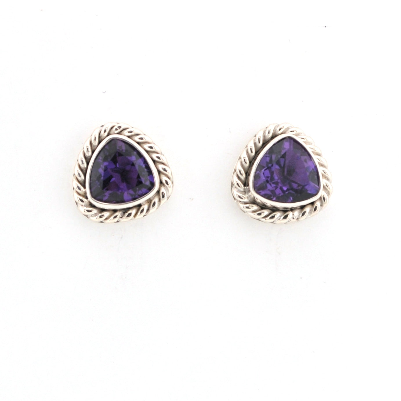 Pair of purple gemstone earrings with gold accents on a white background
